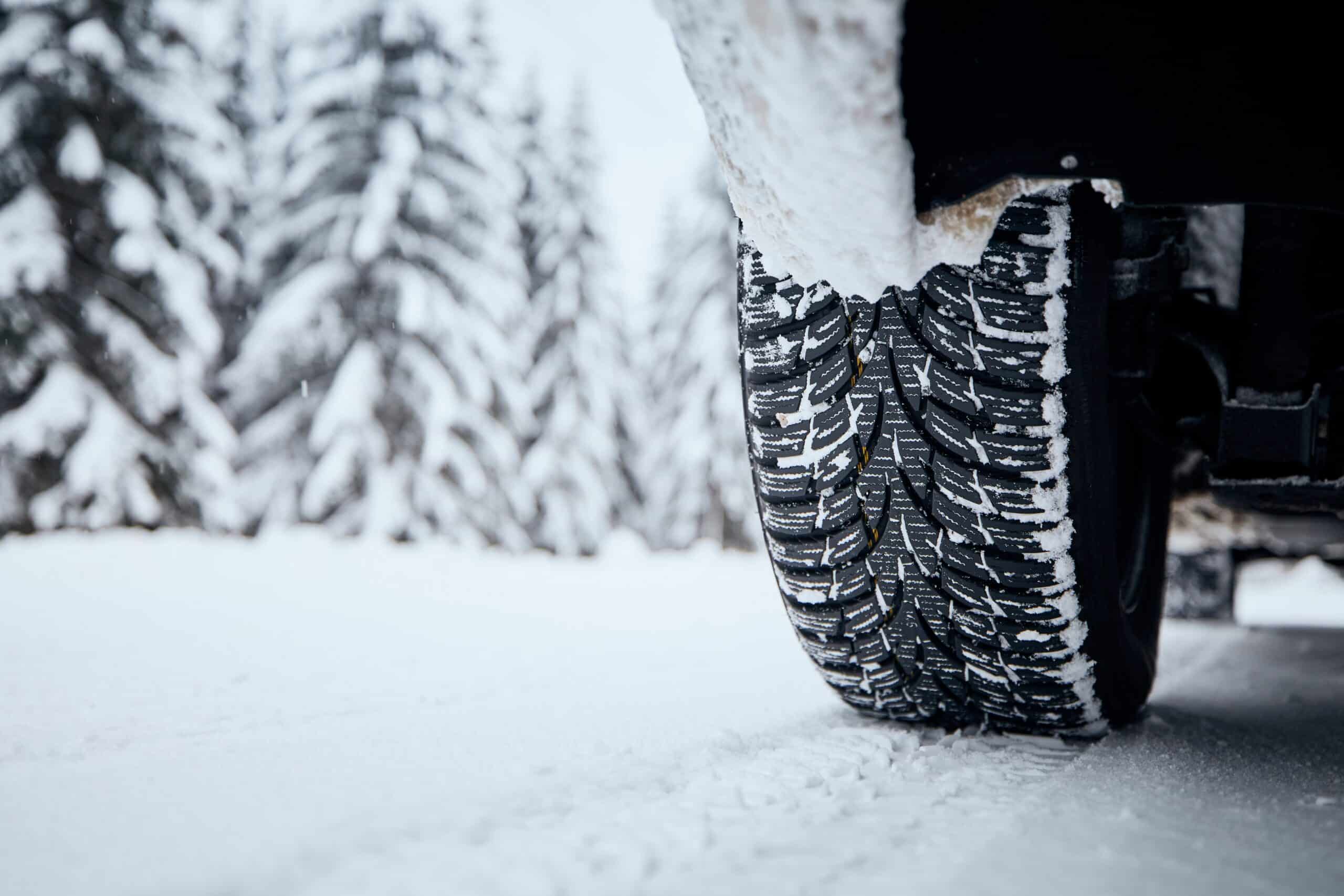 tire of car on snow covered and icy road